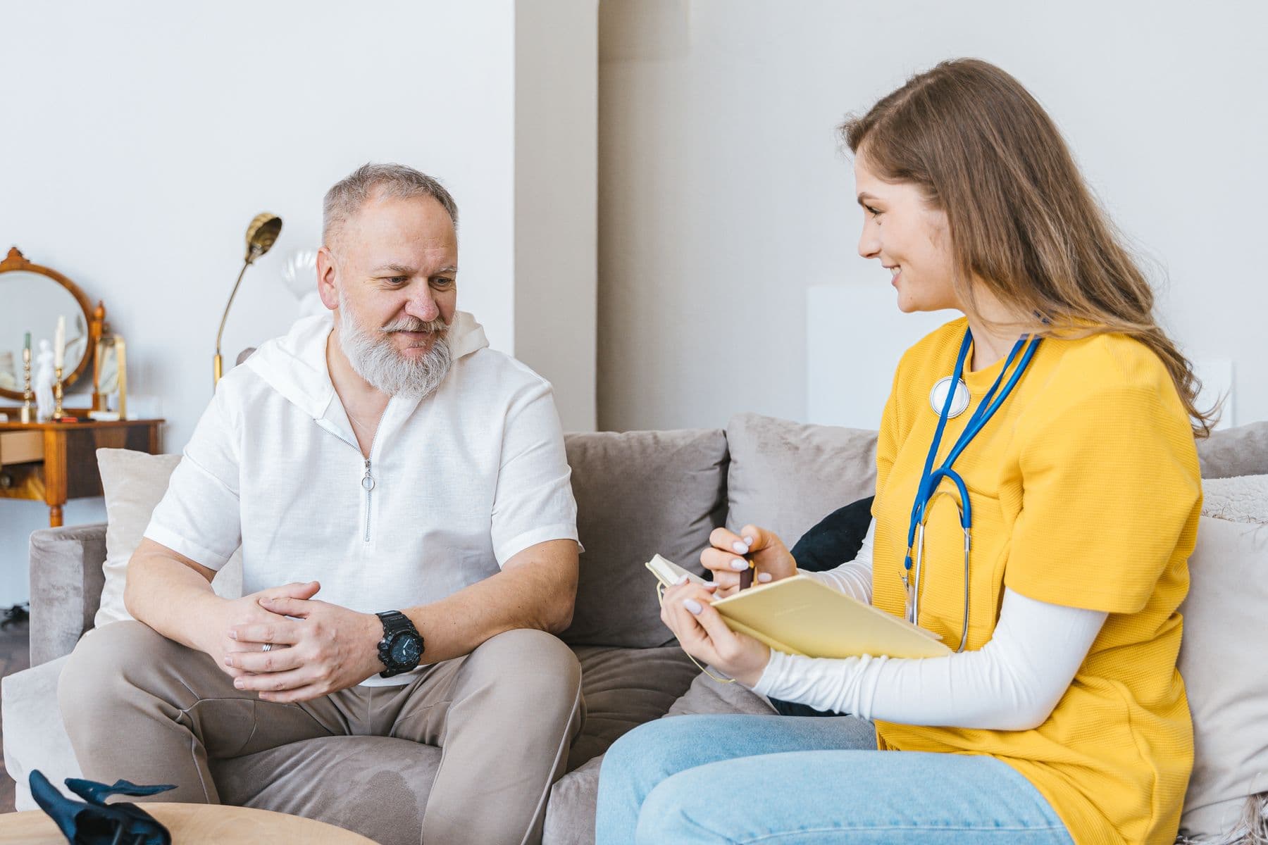 A coordinator sitting with an older person and explaining next steps