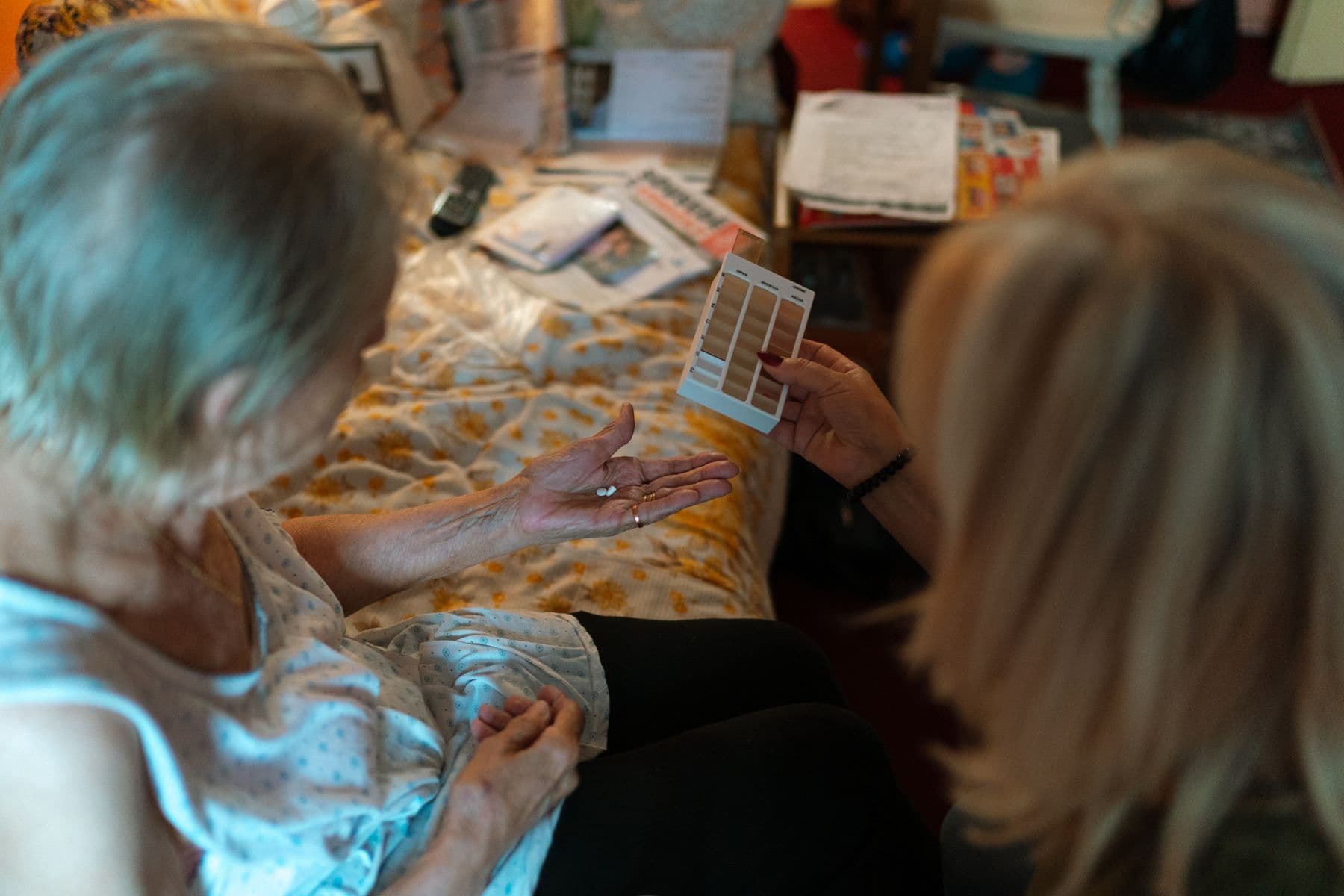 A carer helping with medication and plan supports at home
