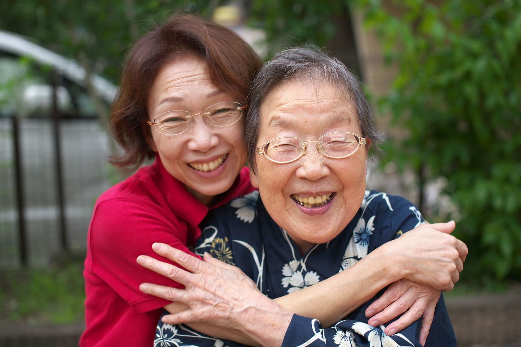 A family carer and older relative sharing a warm embrace